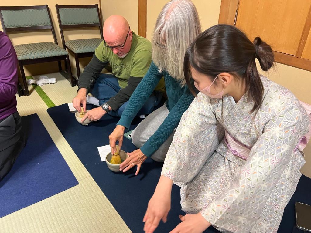 Guests preparing matcha during the tea ceremony experience